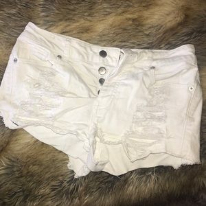 White denim, distressed shorts. Button fly